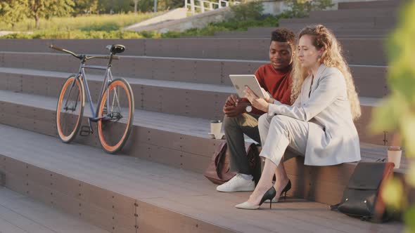 Business Partners Working on Digital Tablet Outdoors