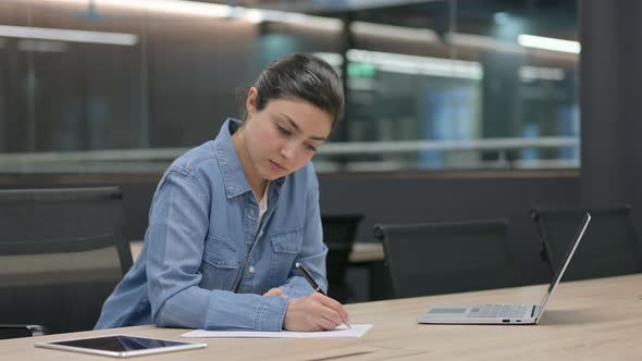 Indian Woman Writing on Paper at Work