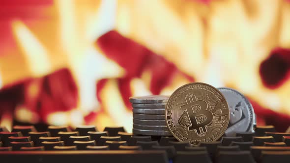 Cryptocurrency Bitcoin and Litecoin on Blurred Background of Burning Fire