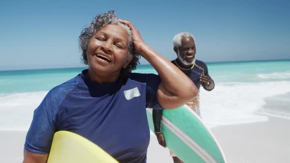 Senior couple with surfboards at the beach