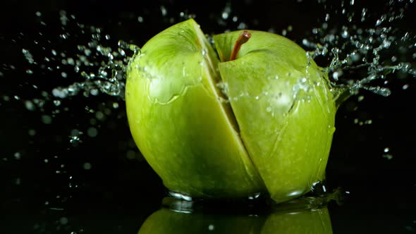 Super Slow Motion Shot of Fresh Green Apple Falling Into Water Isolated at 1000Fps.