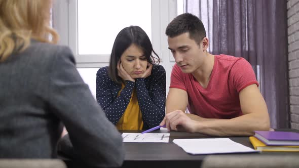 Couple Looking at House Project with Architect