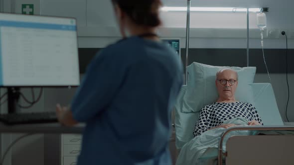 Elderly Patient Waiting for Results in Hospital Ward Bed