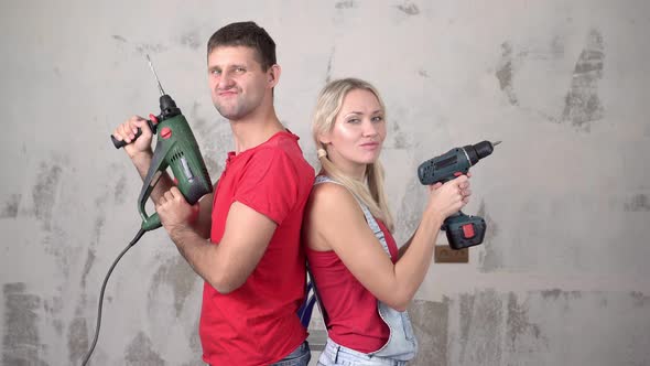 Young Couple or Family with Construction Tools During Home Renovation or Construction.