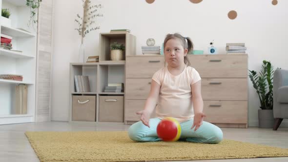 Girl with Down Syndrome Playing with Ball