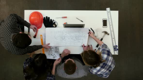 Group of Young Architects Working on Drawings