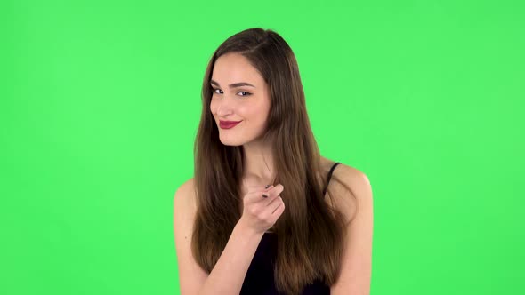 Girl Listens Carefully, Threatens with a Finger and Waves Her Head Seductively. Green Screen