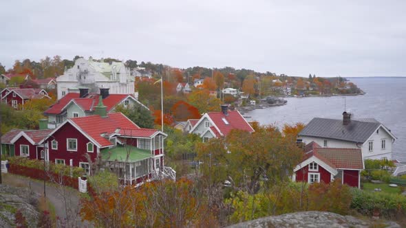 traditional swedish houses on a coastal town in sweden. It's autumn and the trees are colorful and t