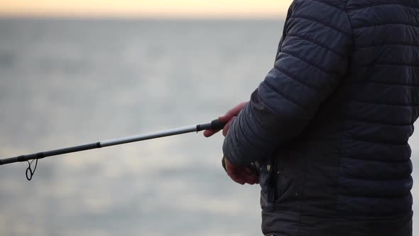 Man Hobby Fishing on Sea Tightens a Fishing Line Reel of Fish Summer