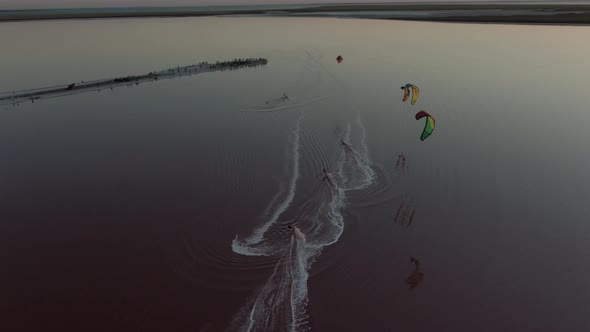 Drone Footage of Kite Surfers Gliding on Pink Water of the Lake, Nature, 