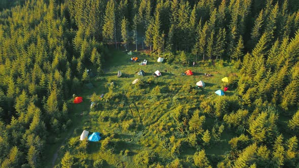 Flight Over a Tent Camping Group of Tourists in the Mountains at Sunrise