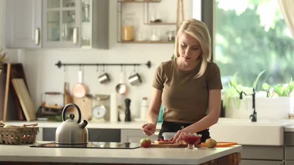 mom prepares lunch box for a child in school on a kitchen at home