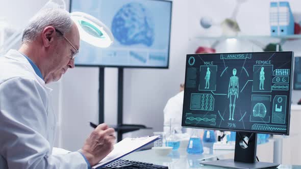 Static Shot of Scientist in a Lab Looking at Computer alt