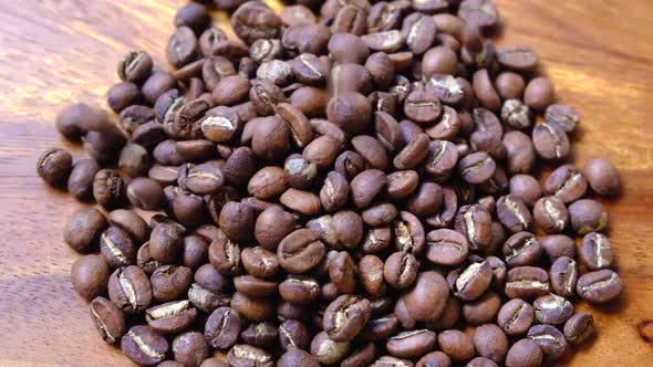 Light Roasted Coffee Beans Falling On The Wooden Background
