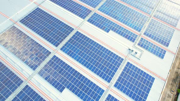 Aerial cinematic view of a solar panel on mall roof top