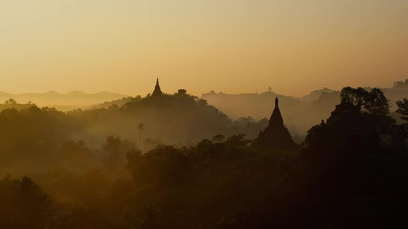 Time Lapse of morning fog and smoke moving past ancient temples in Myanmar alt