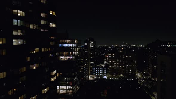 Aerial drone forward moving shot of high-rise office and residential buildings at night time in Chic