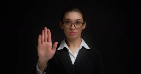 Business Woman Shows a Stop Sign with Her Hand