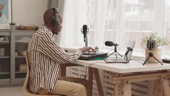 African Man Making Electronic Music Using Daw