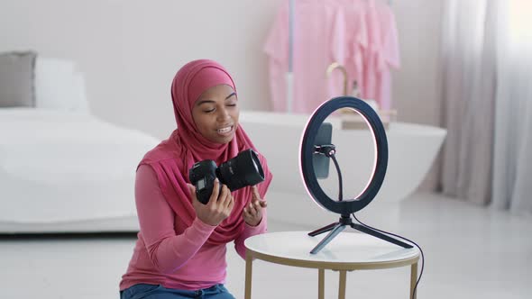 Young Black Muslim Lady Blogger Recording Video on Smartphone Telling About Her New Photography