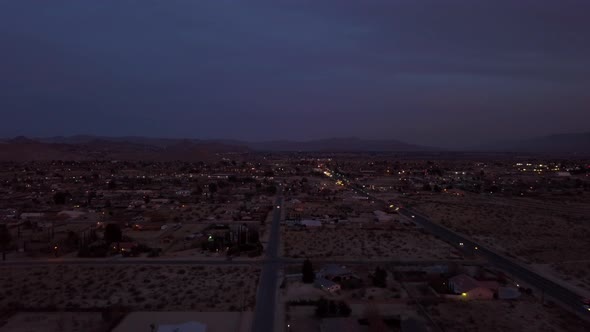 Late evening drone view over High Desert city of Victorville, CA