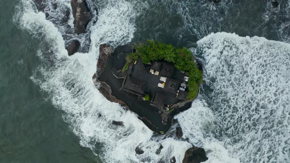 Overhead Top Down View of Tanah Lot Temple Surrounded By Dangerous Sea Waves
