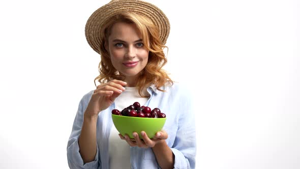 Sexy Pretty Lady in Straw Summer Hat Eating Sweet Cherry Berry Sensually Seasonal Fruit