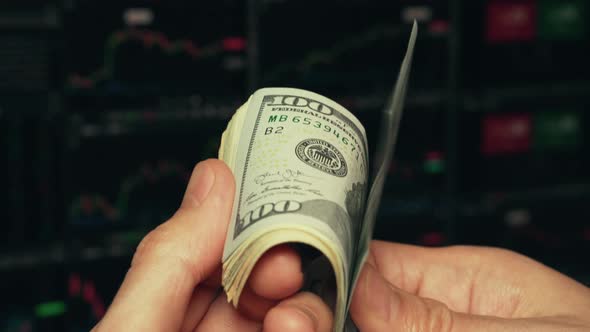 Trader checking and counting dollar banknotes