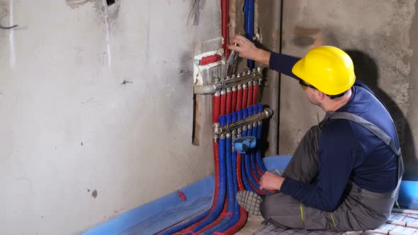 A Plumber Installs Heating in a New House