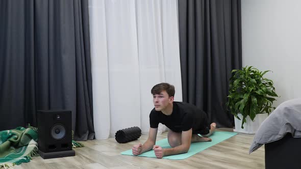 Man stretching after hard indoor workout training