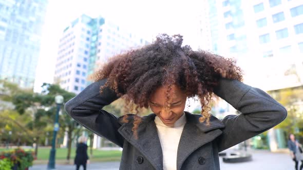 Curly woman laughing and shaking head, slow motion