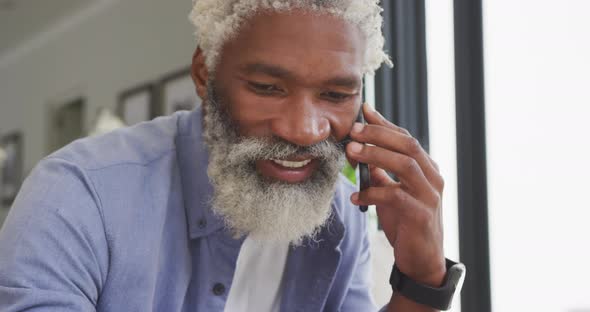 Video of african american senior man using smartphone