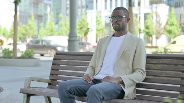 African Man Standing and Leaving After Sitting on Bench Outdoor