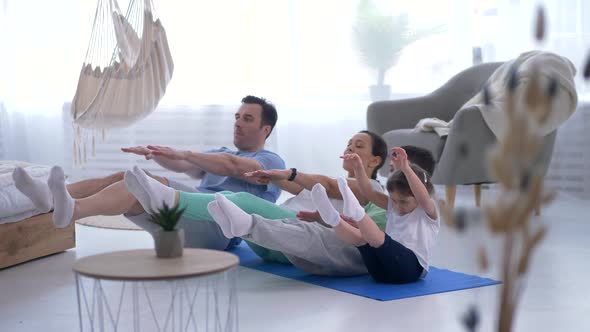 Happy Family with Kids Practicing Yoga Together