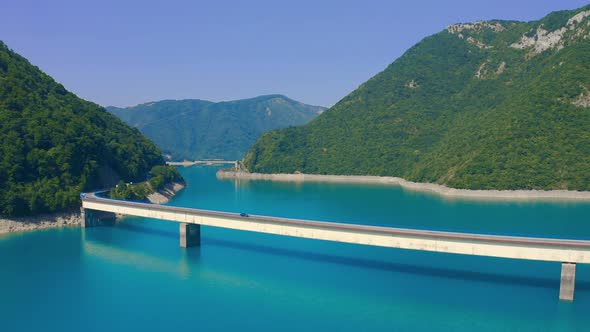 Aerial View Piva Lake with a View of the Mountains and the Bridge