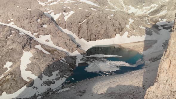 Aerial Crane Shot Unveiling Mountain and Alpine Lake Antermoia  in Dolomites Italy