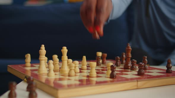 Close Up of Black Woman Moving Chess Pieces on Board