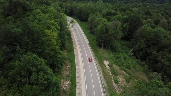 Drone Point of View Tracking Mode Aerial View Flying Over Two Lane Countryside Forest Road with