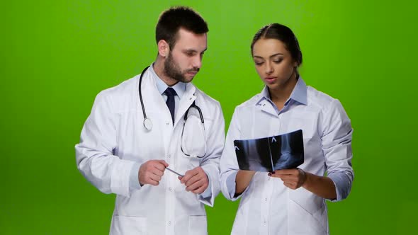 Woman Nurse Consults with a Doctor for Further Treatment Patient