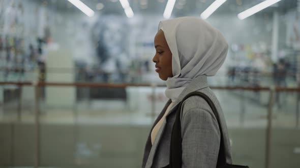 Happy AfricanAmerican Lady with Hijab in Shopping Mall
