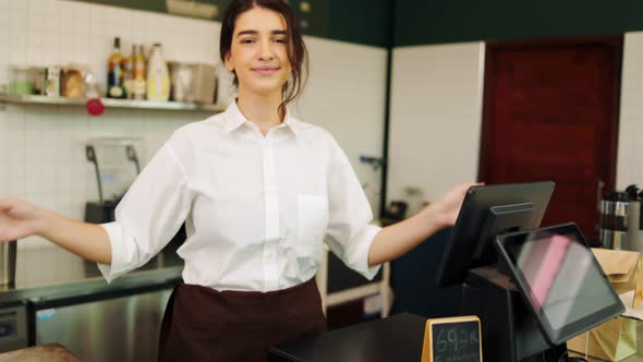 Portrait young Asian woman barista feeling happy smiling at urban cafe