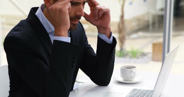 Businessman working on laptop at desk 4k