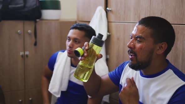 Soccer player drinking water in the locker room