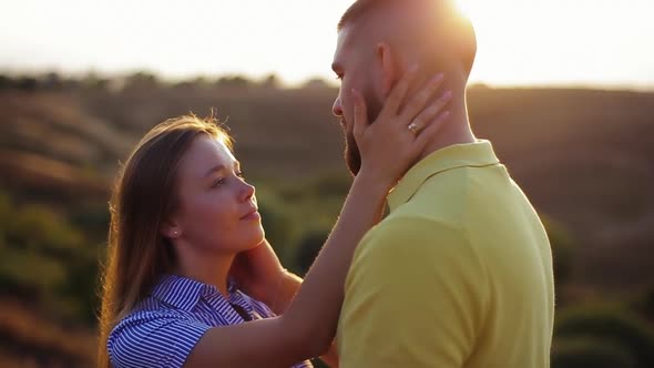 Close-up View of Beautiful European Girl with Loving Gaze Stroking Face of Bearded Guy, Hugging
