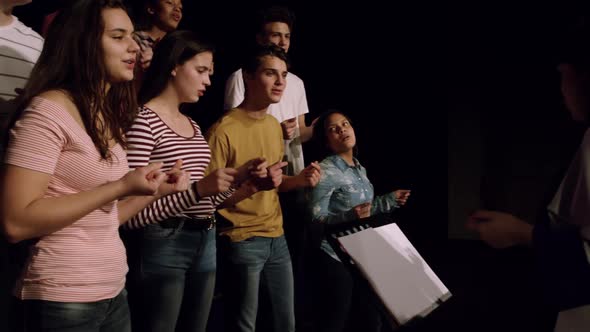 Teenagers rehearsing in a theatre alt