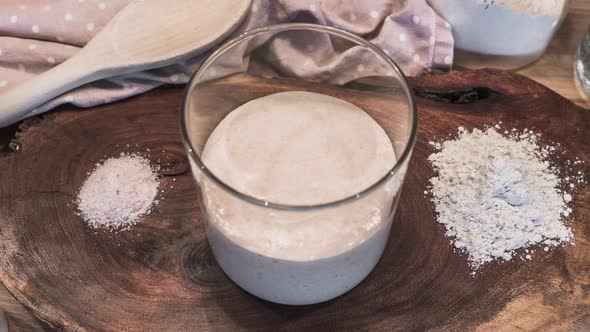 Sourdough Starter Fermentation Process - Flour And Water Mixture Rising In A Glass Jar - timelapse,