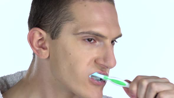 Guy Standing in Profile, Cleans Their Teeth. Close-up. Slow Motion