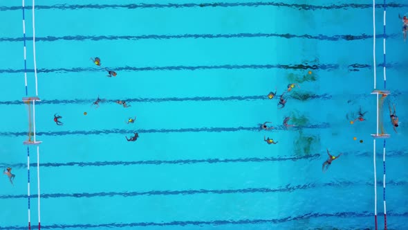 Aerial View Shot of People Competing in Water Polo in Turquoise Water Pool