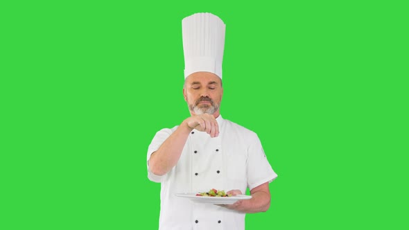 Senior Chef Add Spices in Salad on a Green Screen Chroma Key