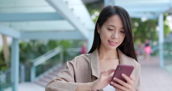 Woman sending text message on cellphone